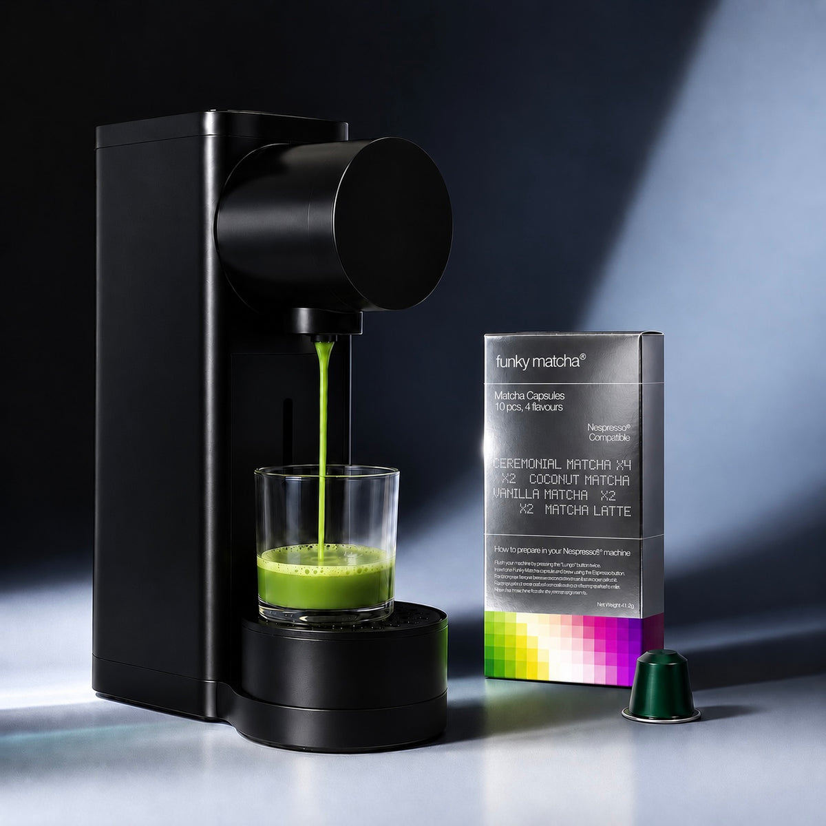 Nespresso® Original machine brewing green matcha beside the Funky Matcha Signature Selection box